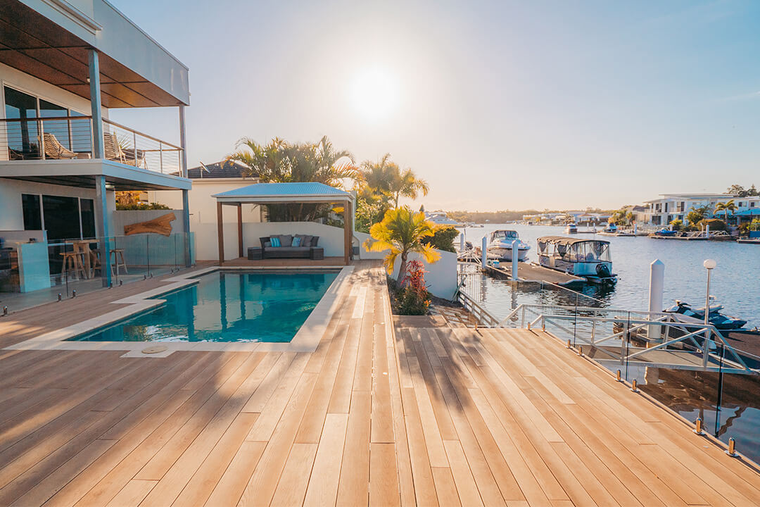 Sunset over millboard deck by water